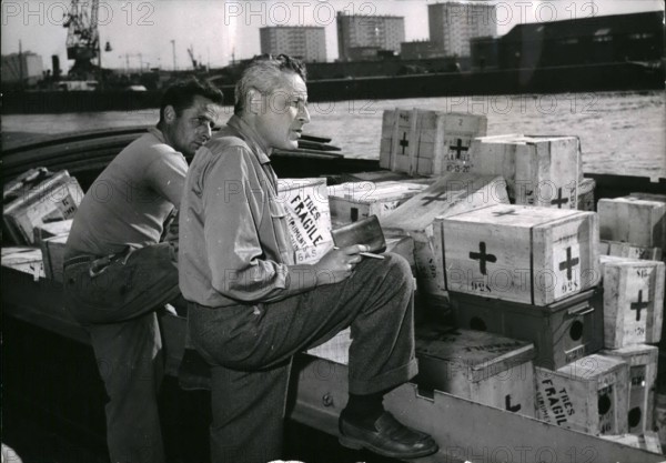 Oct. 10, 1955 - Paul-Emile Victor on the new antarctic expedition : Paul-Emile victor, the famous french polar explorer, is shortly to sail on board the ''Norsel'' now in the port of rouen on a new expedition to the south pole. Paul (Emile victor (right) pictured on the port of rouen while supervising the loading of his equipment.