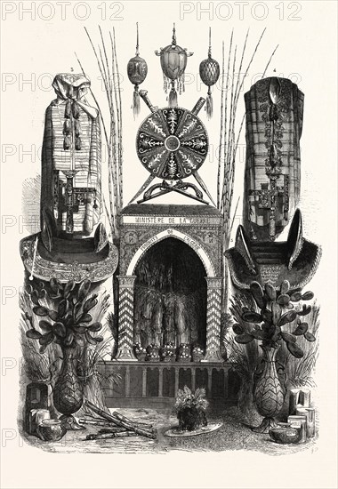 PALACE OF INDUSTRY. Gallery Annex. Products of Algeria. 1. ostrich eggs, decorated with trimmings, Abd-el-Kader Ben Hamed, Tlemcen 2. Embroidered cushion Kaddour Ben Marabet 3 and 4, bumous and gandourah, by Solal, algiers 5. seat and headrest in black velvet, by Mohammed Ben Bouzian and Abd-el-Kader Ben Hamed, Tlemcen 6. seat and headrest in red velvet, by Moustapha Ismail Khodja 7. cereals, fruits, bamboo, wood, cane, ceramics, etc. Paris, France, Exposition Universelle. An international Exhibition held on the Champs-Elysees in 1855, consisting of an industrial and an beaux Arts exposition. engraving 1855