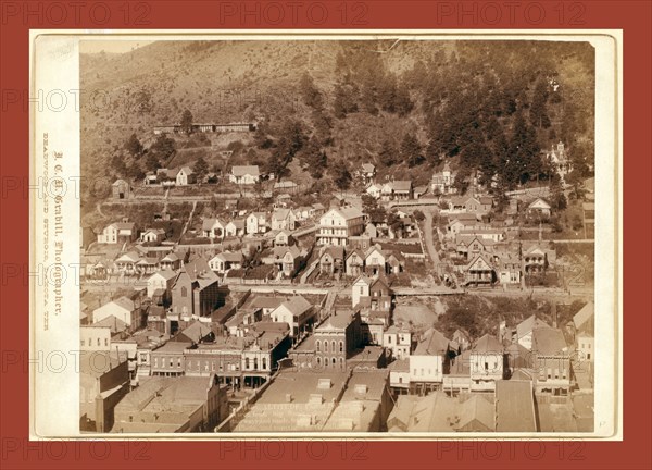 Altitude. Part of Deadwood as seen from big flume, showing steps, stairways, and roads from store to residence, John C. H. Grabill was an american photographer. In 1886 he opened his first photographic studio