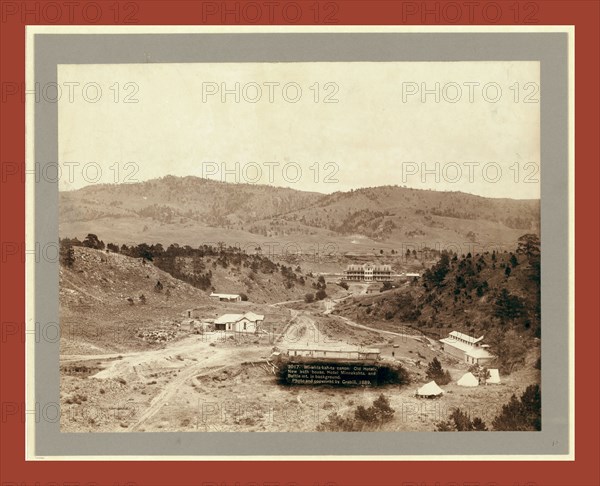 Wi-wi-la-kah-ta canon. Old hotel, new bath house, Hotel Minnekahta and Battle Mt. in background, John C. H. Grabill was an american photographer. In 1886 he opened his first photographic studio
