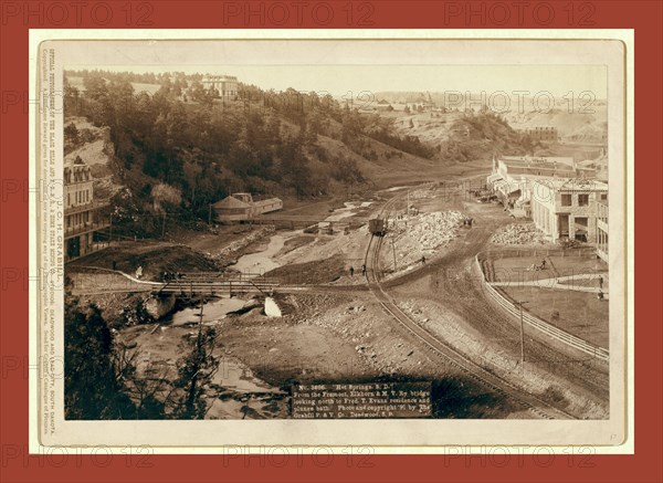 Hot Springs, S.D. From the Fremont, Elkhorn and M.V. Ry. bridge looking north to Fred T. Evans residence and plunge bath, John C. H. Grabill was an american photographer. In 1886 he opened his first photographic studio