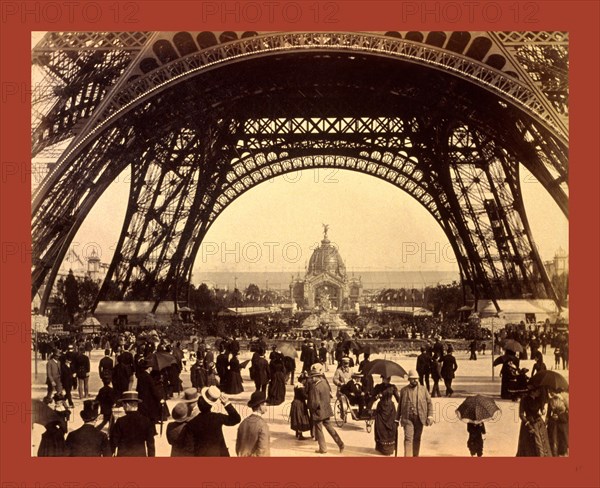 Crowd of people walking under the base of Eiffel Tower, view toward the Central Dome, Paris Exposition, 1889, France
