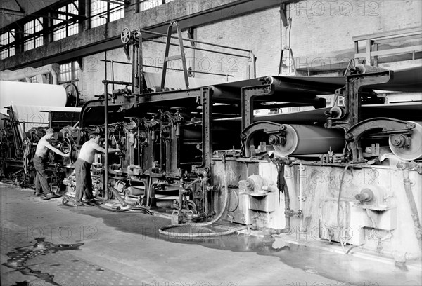 Mt. Holyoke, Massachusetts - Paper. American Writing Paper Co. Cyliner machine (making matchboard), 1936, Lewis Hine, 1874 - 1940, was an American photographer, who used his camera as a tool for social reform. US,USA