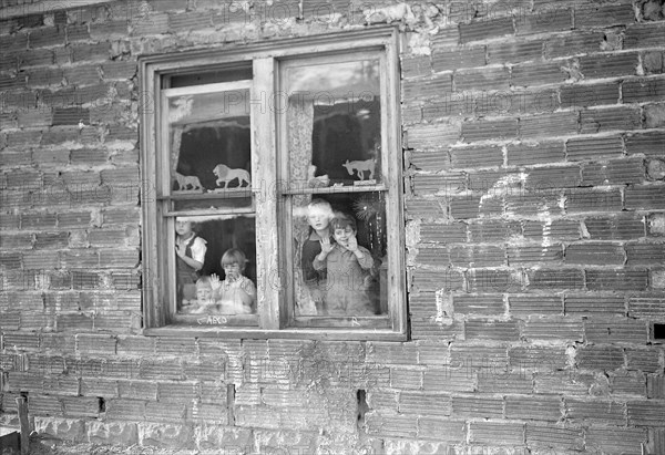 Scott's Run, West Virginia. This building is a part of the abandoned mine buildings of the stranded camp of Jere. It is the exterior of the old fan house. The children are a part of a WPA nursery now functioning in the camp, March 1937, Lewis Hine, 1874 - 1940, was an American photographer, who used his camera as a tool for social reform. US,USA