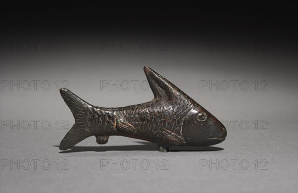 Small Lepidotus Fish, 305-30 BC. Egypt, Probably Ptolemaic Dynasty. Bronze, hollow cast; overall: 1.2 cm (1/2 in.); with tang: 4.2 cm (1 5/8 in.); without tang: 3.2 cm (1 1/4 in.).