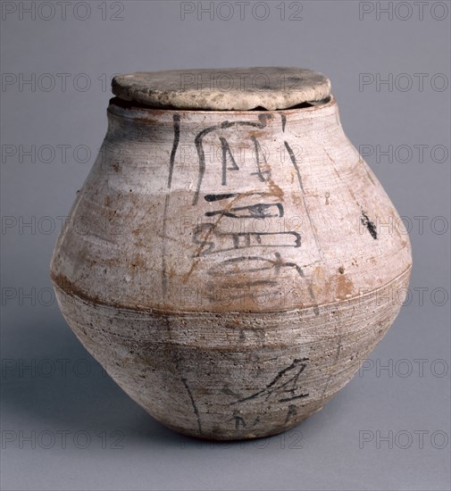 Shawabty Jar with Lid, 1295-1069 BC. Egypt, New Kingdom, Dynasty 19 (1295-1186 BC) - Dynasty 20 (1186-1069 BC). Nile silt ware; lid of limestone; diameter: 23.5 cm (9 1/4 in.); diameter of mouth: 11.3 cm (4 7/16 in.); overall: 22.9 cm (9 in.).