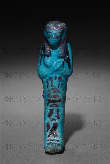 Shawabty of Shedsuhor, 1000-945 BC. Egypt, Third Intermediate Period, Late Dynasty 21 (1069-945 BC). Turquoise faience with dark purle decoration; overall: 10.7 x 4 x 3 cm (4 3/16 x 1 9/16 x 1 3/16 in.).