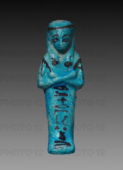 Shawabty of Herytwebkhet (Harweben), 1000-945 BC. Egypt, Third Intermediate Period, Late Dynasty 21, 1069-945 BC. Turquoise faience with black decoration; overall: 11 x 4 x 3.2 cm (4 5/16 x 1 9/16 x 1 1/4 in.).