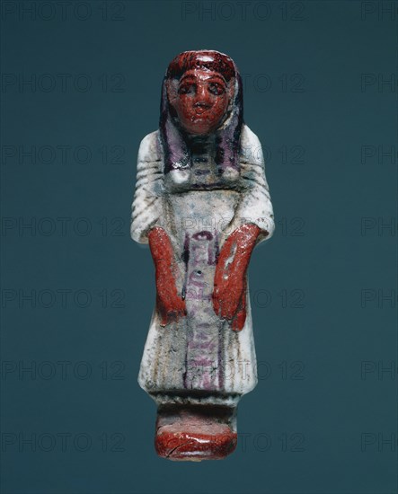 Shawabty in Dress of Everyday Life, 1295-1186 BC. Egypt, New Kingdom, Dynasty 19. Polychrome faience; overall: 13.5 x 5 x 3.2 cm (5 5/16 x 1 15/16 x 1 1/4 in.).