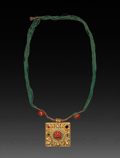 Charm Case, 1800s. Tibet, 19th century. Gold with jewels; overall: 7.2 x 7.8 cm (2 13/16 x 3 1/16 in.); cord: 94 cm (37 in.).