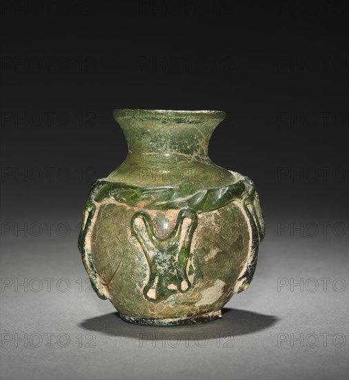 Vase, 7th-9th Century. Early Islamic, Eastern Mediterranean. Glass; overall: 6.1 x 5.5 x 3.3 cm (2 3/8 x 2 3/16 x 1 5/16 in.); diameter of foot: 3 cm (1 3/16 in.).