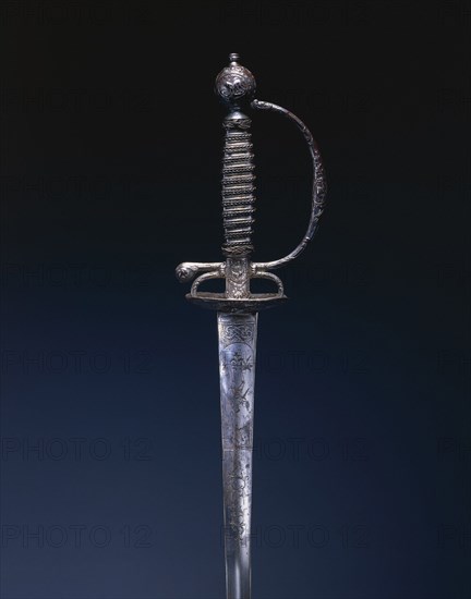 Small Sword, c.1770-1780. France, 18th century. Steel; chiseled relief decoration; blade engraved; wire grip; overall: 97 cm (38 3/16 in.); blade: 79.2 cm (31 3/16 in.); grip: 13.8 cm (5 7/16 in.); guard: 7.6 cm (3 in.).