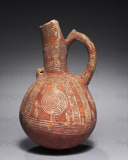 Jug, c. 2000-1800 BC. Cyprus, from Alambra or Ayia Paraskeve, Early Cypriot III-Middle Cypriot I. Red ware; diameter: 10.4 cm (4 1/8 in.); overall: 16.5 cm (6 1/2 in.).
