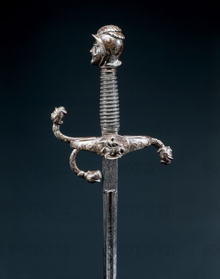 Rapier, c. 1600. Germany, Solingen, early 17th Century. Russeted and gilded steel with inlaid silver, pommel and quillons termini chiseled in form of warrior heads; overall: 125.4 cm (49 3/8 in.); blade: 111 cm (43 11/16 in.); quillions: 15 cm (5 7/8 in.); grip: 12.7 cm (5 in.).