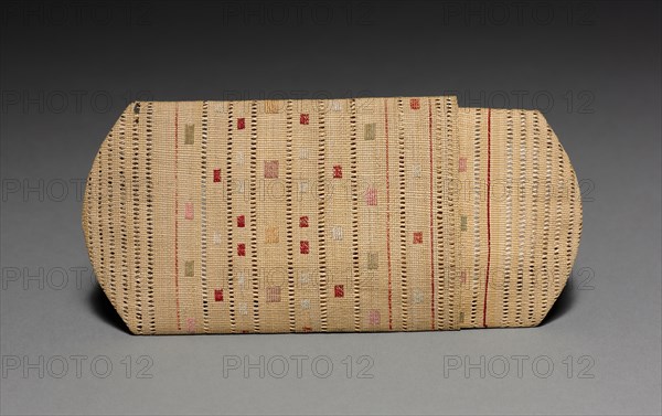 Cigarette or Needle Case, c 1875- 1917 (source unknown). Arctic, Aleut, Attu, Post-Contact. Plain twine, wild rye grass with crossed openwork, patterned twined start, intersecting layered spokes, and plaited finish; silk embroidery (catalogue card); overall: 2 x 11.5 cm (13/16 x 4 1/2 in.).