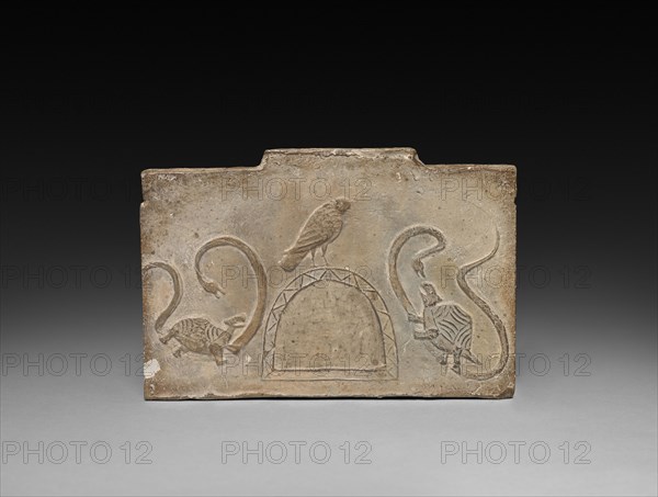 Panel from Model Cooking Stove:  Raven Flanked by Snake-Entwined Tortoises, 1st Century BC. China, from a tomb in Sian-fu, Shensi province, Western Han dynasty (202 BC-AD 9). Earthenware with impressed relief decoration; overall: 12.7 x 18.4 cm (5 x 7 1/4 in.).