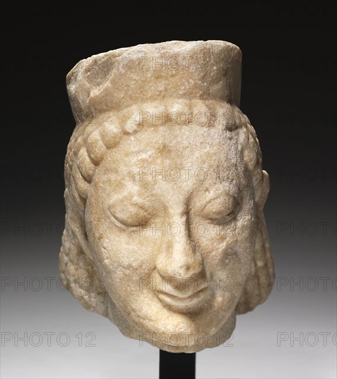 Archaic Head of a Sphinx, 500s BC. Greece, 6th Century BC. Marble; overall: 27 x 20.5 x 26.3 cm (10 5/8 x 8 1/16 x 10 3/8 in.).
