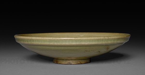 Saucer:  Northern Celadon Ware, Yaozhou type, 12th Century. China, late Northern Song dynasty (960-1127) - Jin dynasty (1115-1234). Glazed stoneware; diameter: 18.4 cm (7 1/4 in.); overall: 4.5 cm (1 3/4 in.).