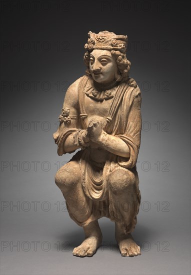 Adoring Attendant from a Buddhist Shrine, c. 300s-400s. Afghanistan, Gandhara, Kushan Period (1st century-320). Stucco; overall: 54.6 cm (21 1/2 in.).