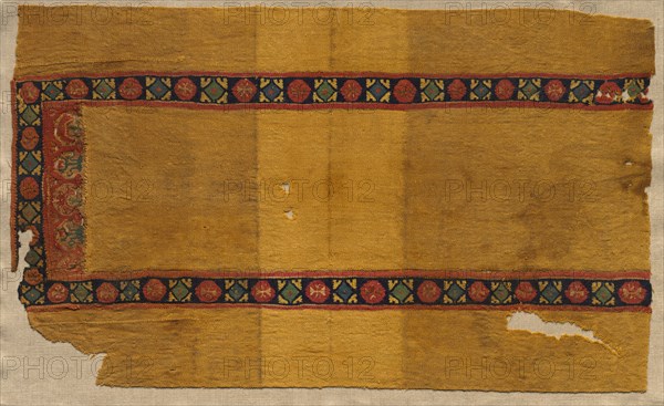 Fragment of a Tunic, 400s - 600s. Egypt, Byzantine period, 5th-7th century. Tabby weave with inwoven tapestry ornament, linen and wool; overall: 38.8 x 64.2 cm (15 1/4 x 25 1/4 in.)