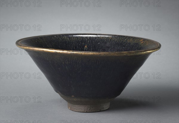 Tea Bowl, 1100s-1200s. China, Fujian province, Southern Song dynasty (1127-1279). Stoneware with black "hare’s fur" glaze and metal-bound rim, Jian ware; diameter: 17.8 cm (7 in.); overall: 8.7 cm (3 7/16 in.).