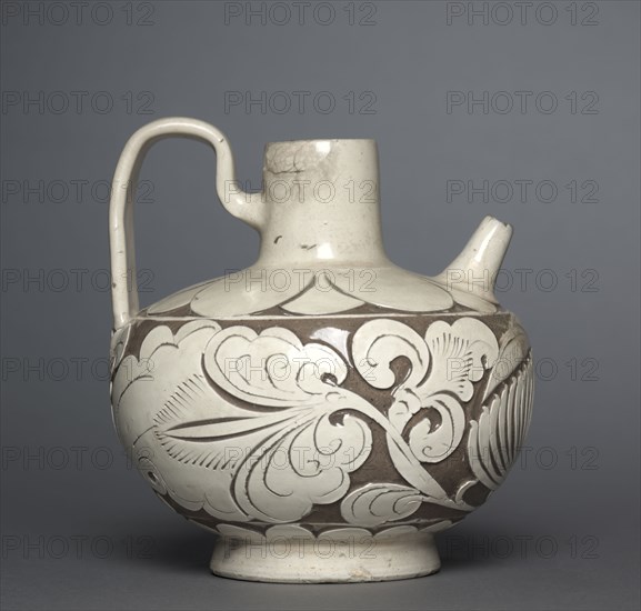 Spouted Ewer with Handle, 900s. Northern China, Northern Song dynasty (960-1127). Glazed stoneware with carved decoration, Cizhou ware; diameter: 15.9 cm (6 1/4 in.); overall: 17.6 cm (6 15/16 in.).