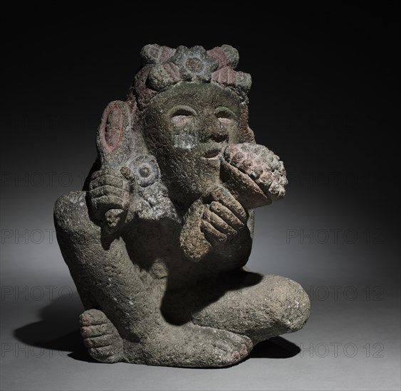 Seated Male Carrying Maize, 1325-1521. Central Mexico, Aztec style, 13th-16th century. Stone, pigment; overall: 31.1 x 24.1 x 30.5 cm (12 1/4 x 9 1/2 x 12 in.).