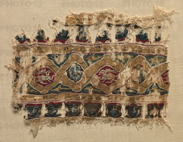 Fragment of a Tiraz-Style Textile, 1081 - 1101. Egypt, Fatimid period, Caliphate of al-Mustansir or al-Musta'li, c. AH 475-495 (A.D. 1081-1101). Tabby ground with inwoven tapestry ornament; linen and silk; overall: 9.6 x 12.1 cm (3 3/4 x 4 3/4 in.)