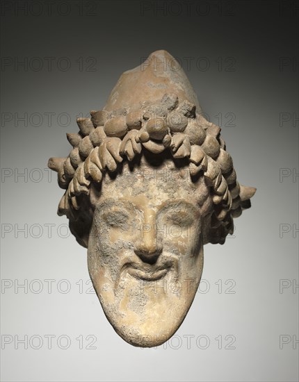 Head of Bearded Dionysus, 6th Century BC. Italy, provincial Greece, 6th Century BC. Terracotta; overall: 20.7 cm (8 1/8 in.).