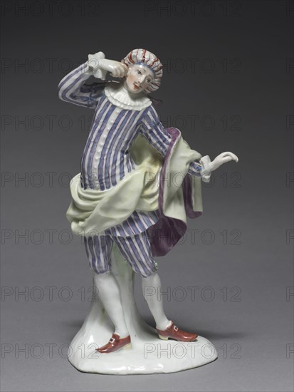 Italian Comedy Figure:  Mezetin, c. 1753. Fürstenberg Porcelain Factory (German), Simon Feilner (German, 1798). Porcelain with enamel decoration; overall: 19.7 x 9.4 x 8.1 cm (7 3/4 x 3 11/16 x 3 3/16 in.).
