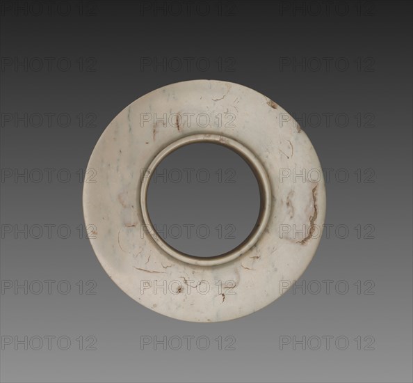 Collared Disk (Huan), c. 1600-1050 BC. China, Shang dynasty (c.1600-c.1046 BC). Jade (nephrite); diameter: 11.4 cm (4 1/2 in.); overall: 1.4 cm (9/16 in.); inner diameter: 8.6 cm (3 3/8 in.).