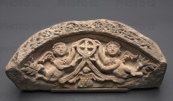 Lunette with Two Angels Supporting a Pendant Cross, 400s. Egypt, 5th century, Coptic period. Limestone; overall: 25.4 x 61 x 21.3 cm (10 x 24 x 8 3/8 in.).