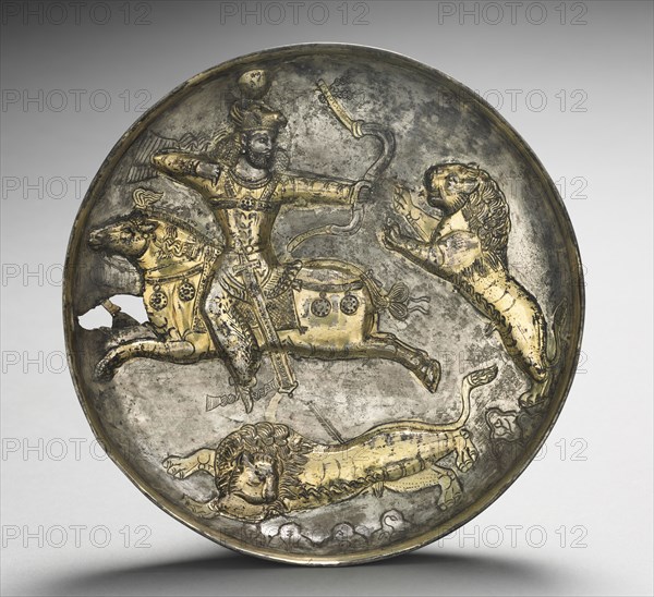 Dish:  King Hormizd II or Hormizd III Hunting Lions, 400-600. Iran, Sasanian, 5th-6th Century. Silver gilt; overall: 4.6 x 20.8 cm (1 13/16 x 8 3/16 in.).