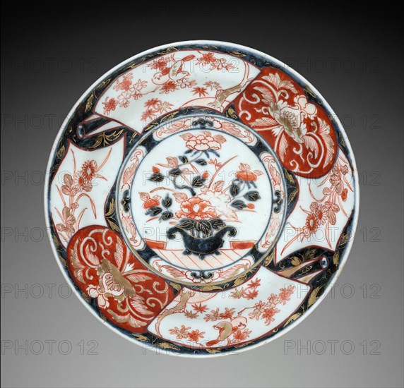 Plate with Vase of Peonies: Imari Ware, c. 1700. Japan, Saga Prefecture, Arita Kilns, Edo Period (1615-1868). Porcelain with decoration in underglaze blue overglaze, and gold; diameter: 24.8 cm (9 3/4 in.); overall: 4.2 cm (1 5/8 in.).