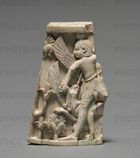 Decorative Plaque: Man; and Griffin in Combat, 900-800 BC. Phoenician, Iraq, Nimrud, 9th-8th Century BC. Ivory; overall: 6.5 x 3.9 cm (2 9/16 x 1 9/16 in.).