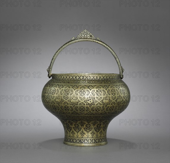 Bath Pail (satl), c. 1580-1610. Iran, Isfahan, Safavid period, late 16th-early 17th century. Cast brass, turned, engraved, inlaid with black compound (niello); overall: 17 cm (6 11/16 in.); diameter of base: 11 cm (4 5/16 in.); diameter of rim: 16.8 cm (6 5/8 in.).