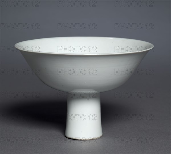 Stem Cup with Buddhist Emblems: Shufu Ware, 1300s. China, Jiangxi province, Yuan dynasty (1271-1368). Porcelain with molded decoration and white glaze; case: 16.6 x 17.8 cm (6 9/16 x 7 in.); overall: 10.2 x 15.3 cm (4 x 6 in.).