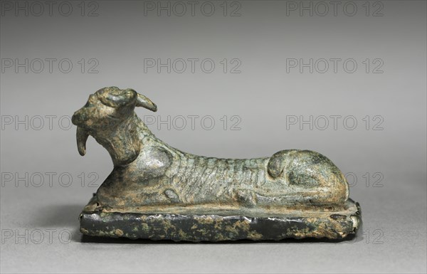 Recumbent Animal on Grater, 700-500 BC. Greece or Asia Minor, 8th-6th Century BC. Bronze with iron grating plate; overall: 4.1 cm (1 5/8 in.); base: 7.6 x 4.3 cm (3 x 1 11/16 in.).