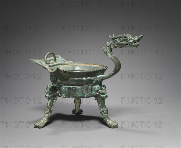 Tripod Container with Dragon-Head Handle (Zhadou), 500s. China, Southern and Northern Dynasties period (386-589). Bronze; overall: 22.8 cm (9 in.); diameter of mouth with rim: 15.5 cm (6 1/8 in.).