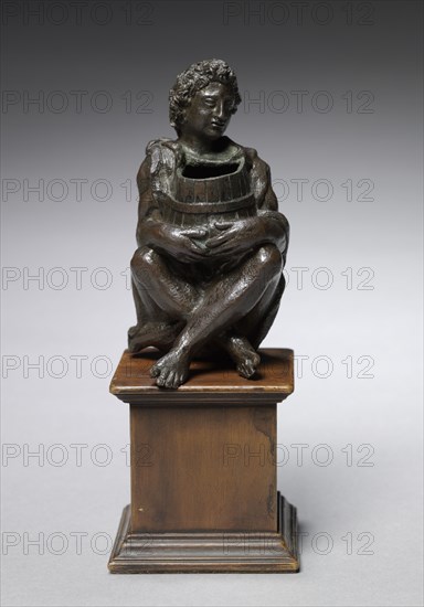 Seated Boy Clothed with Goat Skins Holding an Open Barrel, c. 1525. Italy, Padua, 16th century. Bronze; overall: 11.2 x 6 x 6.5 cm (4 7/16 x 2 3/8 x 2 9/16 in.).