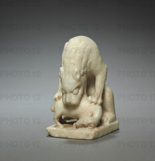 Lion Devouring a Lamb, early 700s. North China, Tang dynasty (618-907). White marble; overall: 14 x 7.6 cm (5 1/2 x 3 in.).