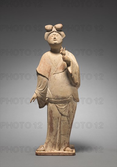 Woman Holding Plum Blossoms, mid 700s. North China, Tang dynasty (618-907). Earthenware covered in white slip with traces of pigment; overall: 43.8 x 16.5 x 12.2 cm (17 1/4 x 6 1/2 x 4 13/16 in.)