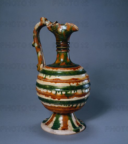 Ewer, 700-750. China, Tang dynasty (618-907). Glazed earthenware, sancai (three-color ware); diameter: 13.5 cm (5 5/16 in.); overall: 27.3 cm (10 3/4 in.).