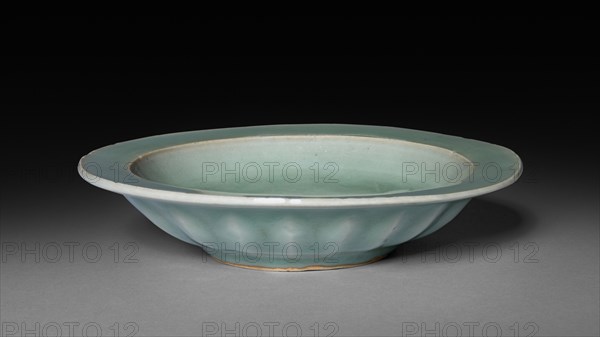 Dish with Two Fish in Relief:  Longquan Ware, early 14th Century. China, Zhejiang province, Yuan dynasty (1271-1368). Glazed porcelain with unglazed molded decoration; diameter: 15 cm (5 7/8 in.); overall: 3.2 cm (1 1/4 in.).