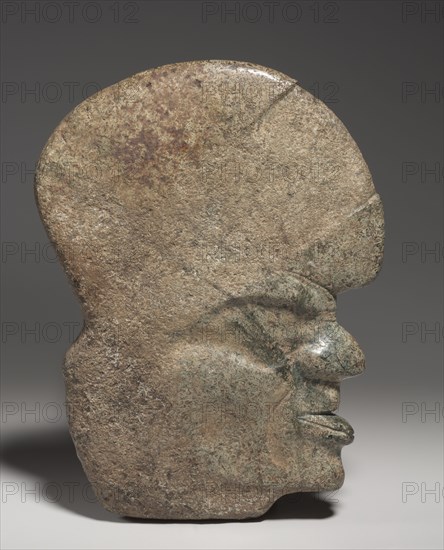 Ballgame Thin Stone Head (Hacha), 600-900. South or southeast Mesoamerica, Classic Veracruz style (600-1100). Stone, pigment traces; overall: 25.3 x 4.5 x 18.6 cm (9 15/16 x 1 3/4 x 7 5/16 in.).