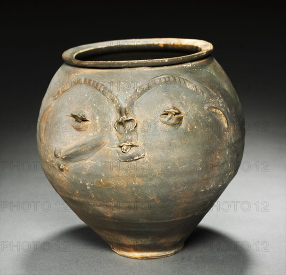Face Urn, 25-50. Rhenish (Cologne), Gallo Roman, 2nd quarter, 1st Century. Reddish ware with gray burnished slip; diameter: 19.5 cm (7 11/16 in.); overall: 19 x 20 cm (7 1/2 x 7 7/8 in.).