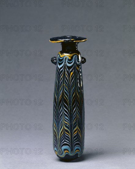 Perfume Bottle (Alabastron), c. 325-275 BC. Italy or Eastern Mediterranean, Etruscan, 4th-3rd Century BC. Glass; diameter: 5.1 cm (2 in.); overall: 16.5 cm (6 1/2 in.).