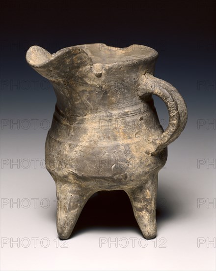 Wine Warmer (Jue), c. 1300-1023 BC. China, Shang dynasty (c.1600-c.1046 BC), Anyang phase (c.1250-1046 BC). Pottery, tripod vessel with loop handle and rudimentary bowstring decoration; diameter: 11 cm (4 5/16 in.); overall: 12.8 cm (5 1/16 in.).