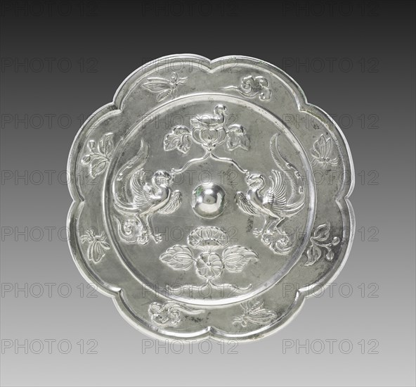 Lobed Mirror with Paired Phoenixes, a Nestling Bird, and a Lotus Blossom, 700s. China, Tang dynasty (618-907). Bronze; diameter: 19.1 cm (7 1/2 in.); overall: 1.1 cm (7/16 in.); rim: 0.7 cm (1/4 in.).