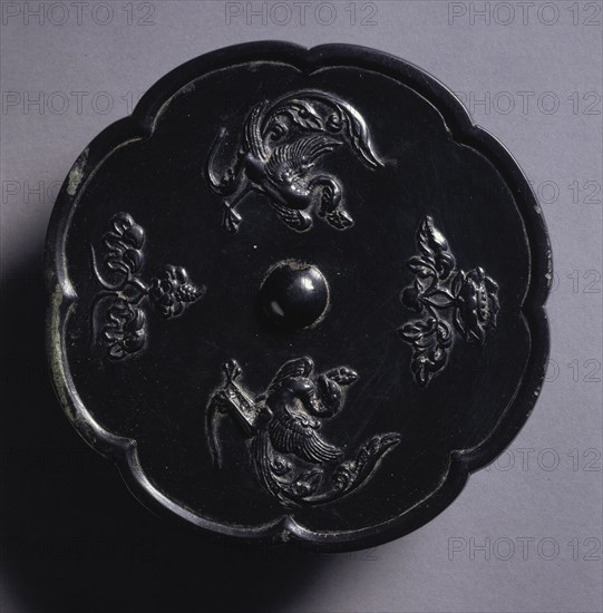 Lobed Mirror with Paired Phoenixes and Floral Displays, 700s. China, Tang dynasty (618-907). Bronze; diameter: 14.8 cm (5 13/16 in.); overall: 1.1 cm (7/16 in.); rim: 0.6 cm (1/4 in.).